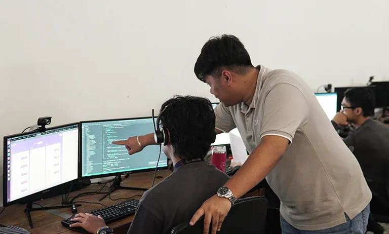 Clark Staff technology outsourcing colleagues collaborating at a workstation